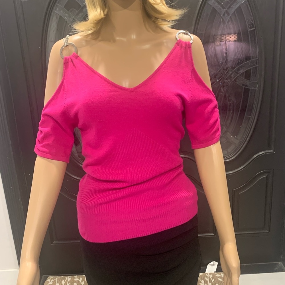 Beautiful modern fuchsia top. Very low cut with chain details. Very unique.